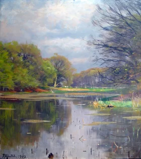 A lake surrounded by trees 1902